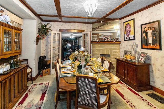 dining area with visible vents, a textured ceiling, and wallpapered walls