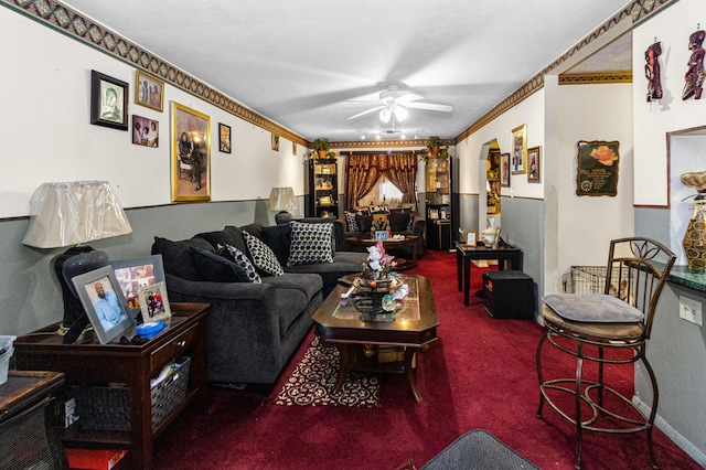 living room featuring carpet, a ceiling fan, and crown molding