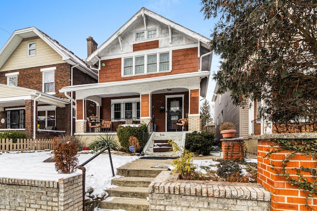 craftsman-style house featuring a porch and brick siding