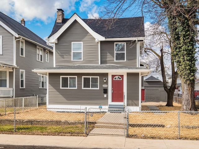 view of front of property featuring entry steps, roof with shingles, a fenced front yard, and a gate