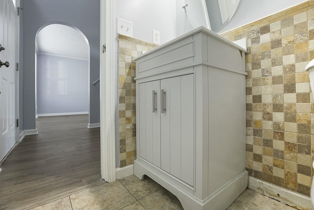 interior space with tile walls and wood finished floors