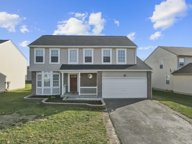 view of front of home featuring driveway, a garage, a front lawn, and brick siding