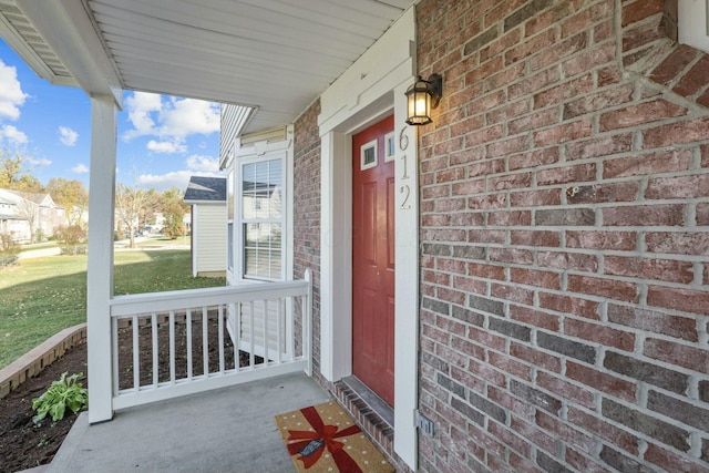 property entrance with brick siding