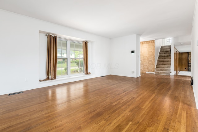 2715 Kenview Rd S, Columbus, OH 43209 - unfurnished living room with stairway, baseboards, visible vents, and wood finished floors