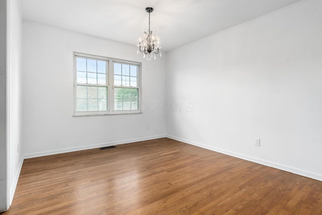 2715 Kenview Rd S, Columbus, OH 43209 - empty room with an inviting chandelier, ornamental molding, baseboards, and wood finished floors