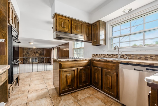 2715 Kenview Rd S, Columbus, OH 43209 - kitchen with under cabinet range hood, a sink, decorative backsplash, black appliances, and light countertops