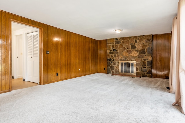 2715 Kenview Rd S, Columbus, OH 43209 - unfurnished living room with a stone fireplace, wooden walls, and carpet floors