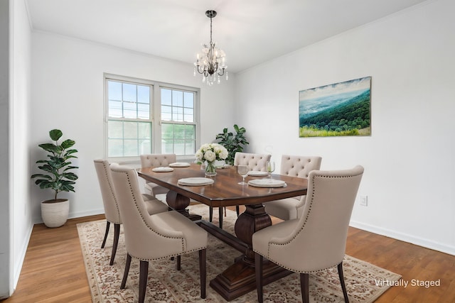 2715 Kenview Rd S, Columbus, OH 43209 - dining room with light wood-style floors, baseboards, ornamental molding, and a notable chandelier