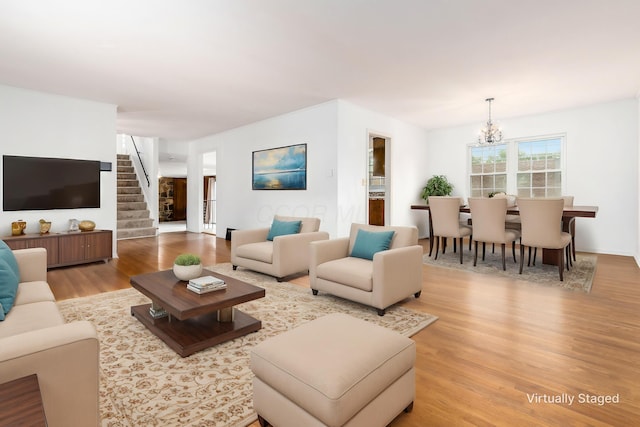 2715 Kenview Rd S, Columbus, OH 43209 - living room with an inviting chandelier, stairway, and wood finished floors