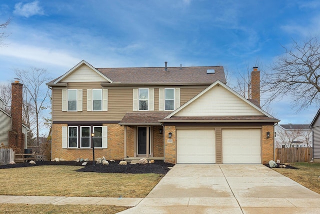 view of front of property with concrete driveway, brick siding, a front yard, and fence