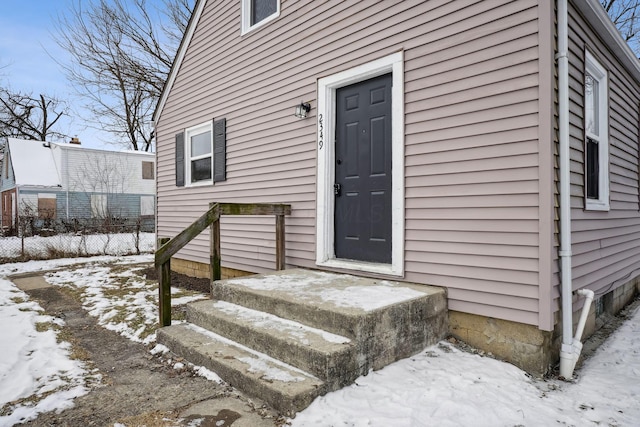 view of snow covered property entrance