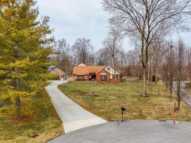 view of front of property featuring brick siding and a front yard