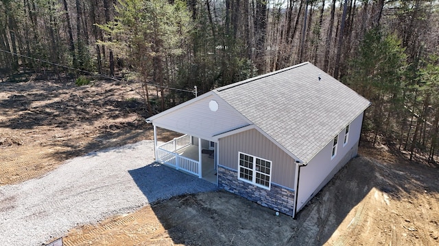 drone / aerial view with a wooded view