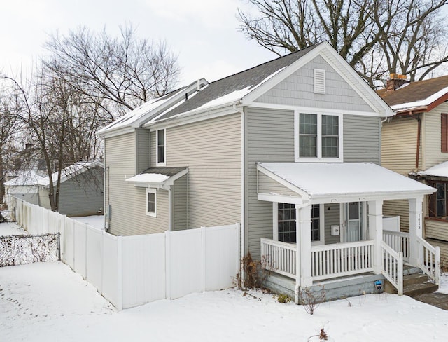 view of front of home featuring fence and a porch