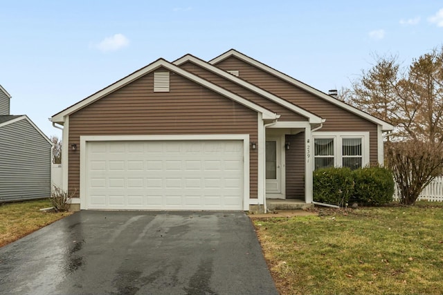 view of front of property with a garage, driveway, and a front lawn