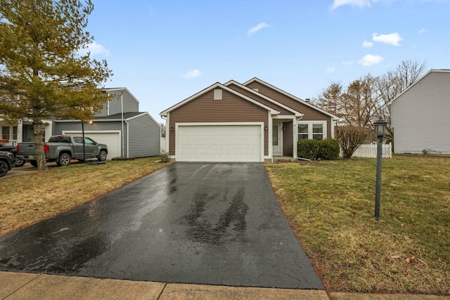 view of front of property with driveway, an attached garage, and a front yard