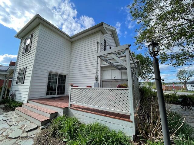 back of property featuring a wooden deck