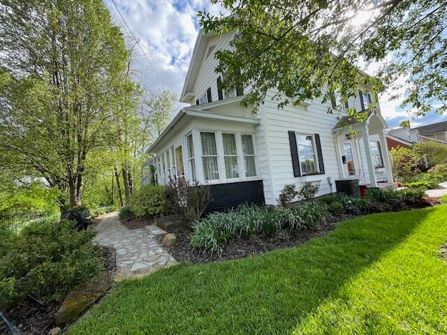 view of property exterior with a lawn