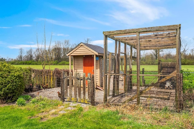 view of poultry coop featuring fence
