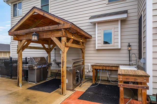 view of patio / terrace featuring fence and grilling area