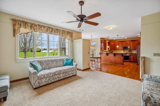 living area featuring a ceiling fan, baseboards, dark carpet, and recessed lighting