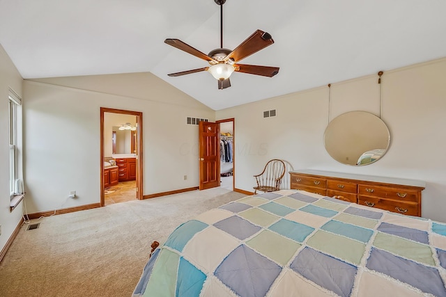 carpeted bedroom featuring baseboards, vaulted ceiling, visible vents, and a walk in closet
