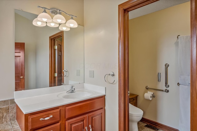 bathroom featuring toilet and vanity