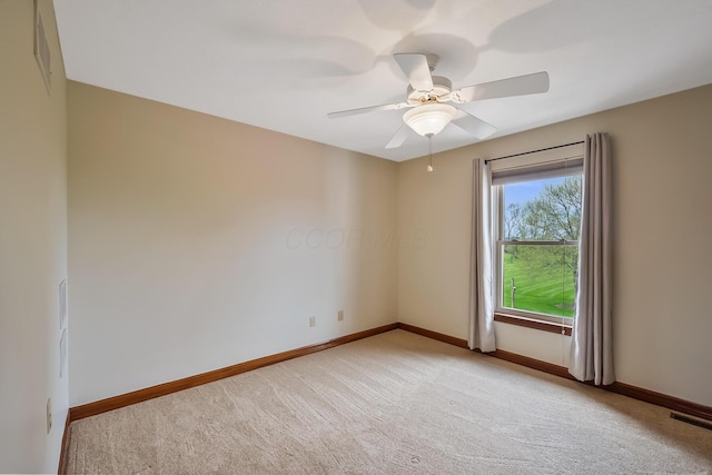 unfurnished room with baseboards, visible vents, a ceiling fan, and light colored carpet