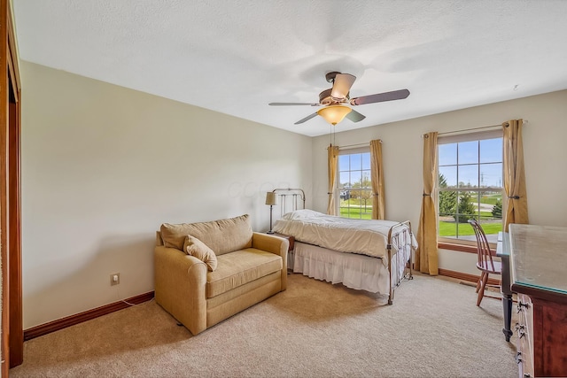 bedroom featuring a ceiling fan, baseboards, and light colored carpet