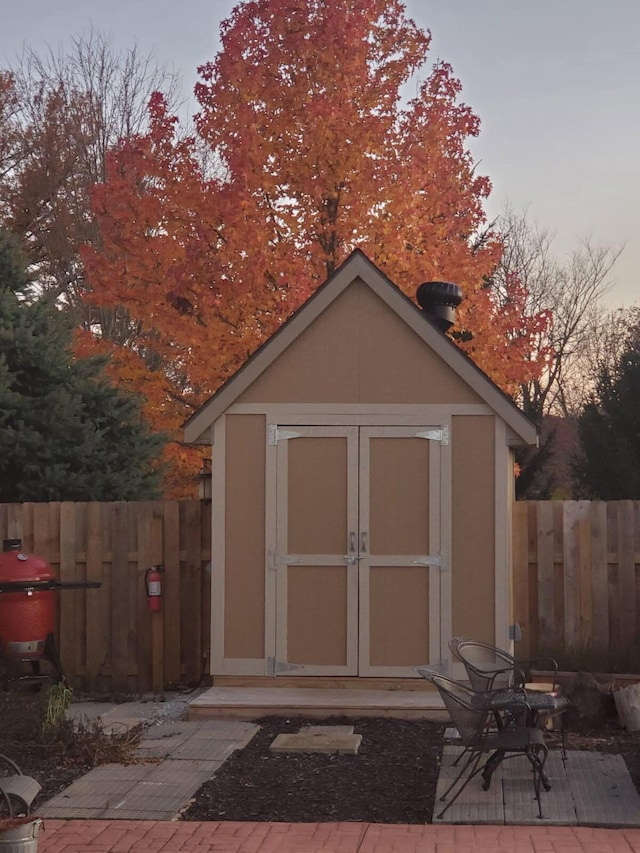 view of shed with fence