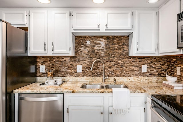 kitchen featuring a sink and white cabinets