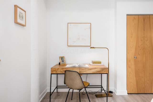 home office featuring light wood-style floors and baseboards