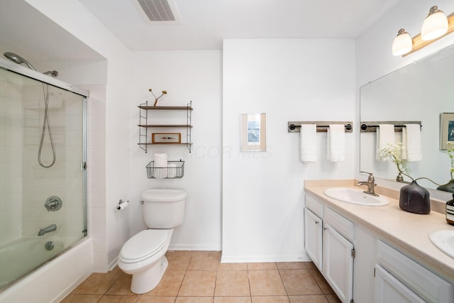 bathroom with tile patterned flooring, toilet, a sink, visible vents, and combined bath / shower with glass door