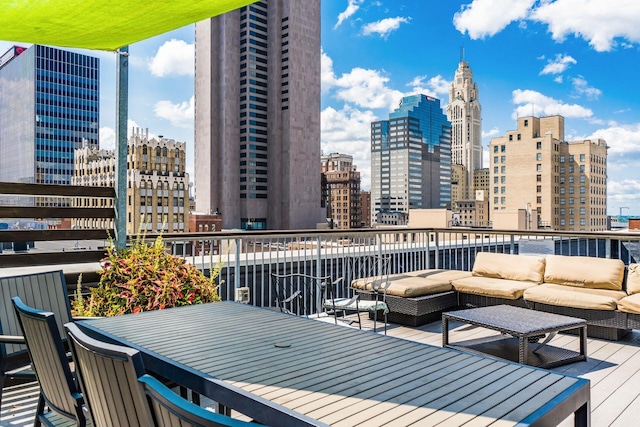 balcony with an outdoor living space and a city view