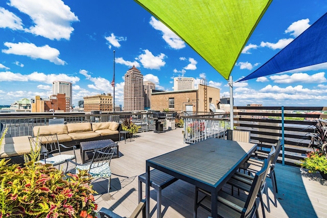 view of patio / terrace featuring an outdoor hangout area, outdoor dining space, and a city view