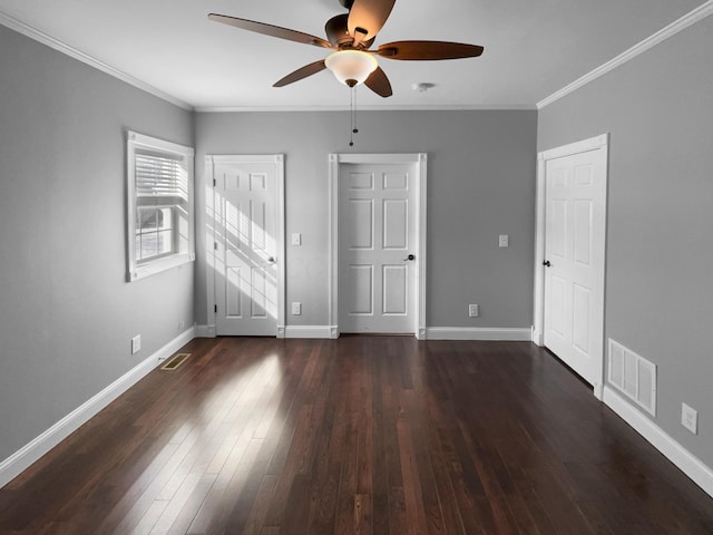 unfurnished bedroom with dark wood-type flooring, visible vents, and crown molding