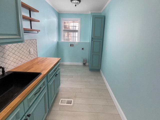 kitchen featuring open shelves, decorative backsplash, ornamental molding, a sink, and butcher block countertops