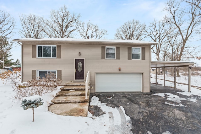 raised ranch with driveway and an attached garage