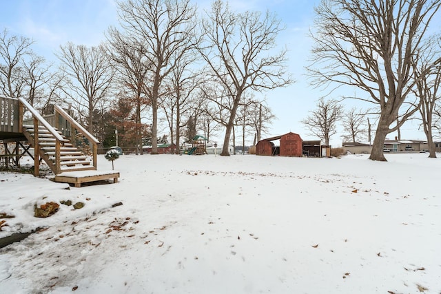 snowy yard featuring a detached garage