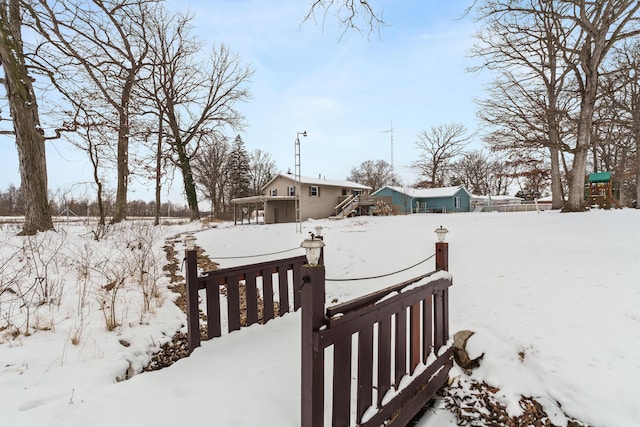 yard covered in snow featuring fence