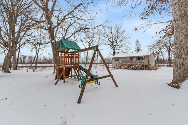 snow covered playground featuring a playground