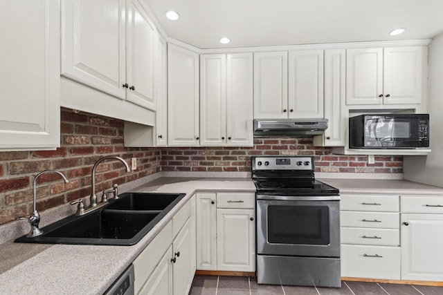 kitchen with black microwave, under cabinet range hood, a sink, light countertops, and stainless steel electric range