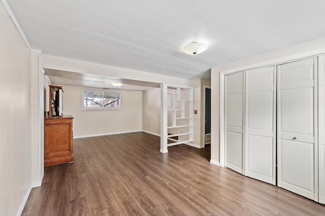 below grade area with baseboards and wood finished floors