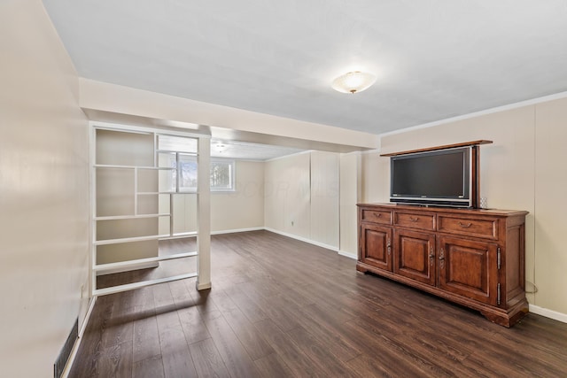 below grade area with dark wood-style flooring and baseboards