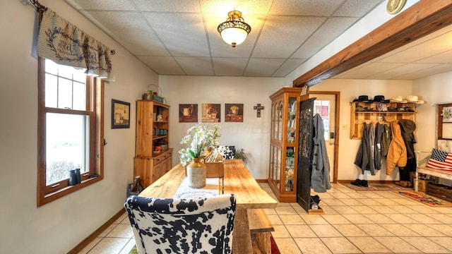 1295 Maple Brook Rd, New Concord, OH 43762 - dining space featuring light tile patterned floors, a paneled ceiling, and baseboards