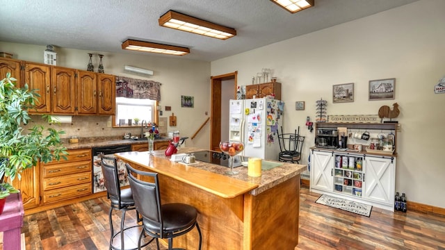 1295 Maple Brook Rd, New Concord, OH 43762 - kitchen featuring a center island, dark wood-type flooring, white fridge with ice dispenser, brown cabinetry, and a sink
