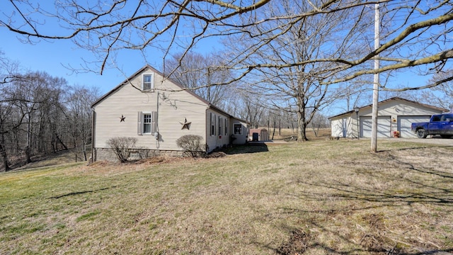 view of home's exterior with a yard and an outdoor structure