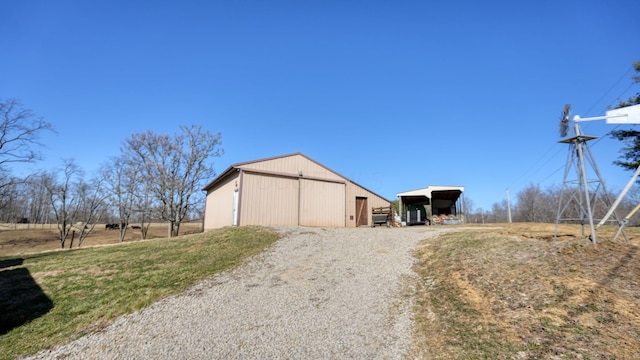 1295 Maple Brook Rd, New Concord, OH 43762 - view of pole building with a carport and gravel driveway