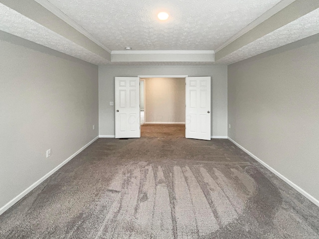 unfurnished bedroom featuring baseboards, dark carpet, and crown molding