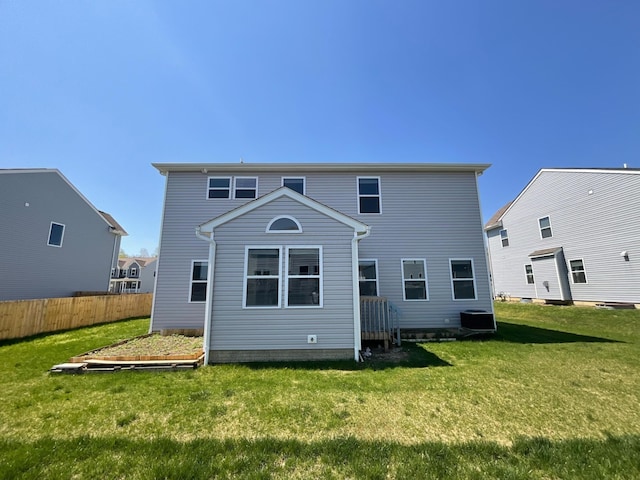 back of house featuring a yard, fence, and cooling unit